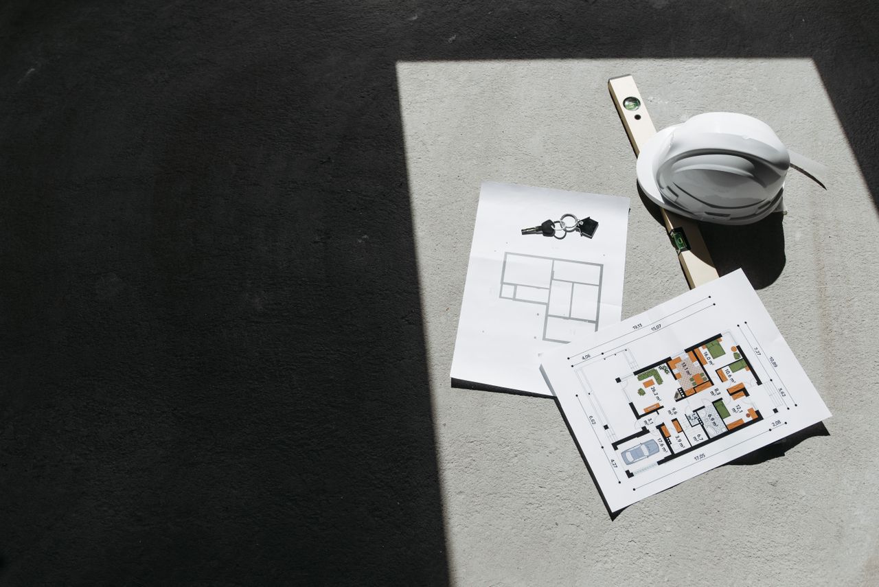 Crafting Captivating Headlines: Your awesome post title goes here Sunlit construction plans and hard hat on site. Perfect for architecture or building project themes.